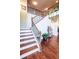 Elegant staircase with wooden steps, iron railings, and an open design at 1185 Gallatin Way, Suwanee, GA 30024