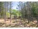 Wooded backyard featuring a trampoline, zipline, and wooden fence bordering the expansive property at 211 Aspen Valley Ln, Dallas, GA 30157