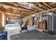 Spacious unfinished basement featuring exposed beams, perfect for creating a home gym with workout equipment at 211 Aspen Valley Ln, Dallas, GA 30157