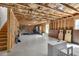 Large unfinished basement with exposed beams, offering endless possibilities for customization with natural light at 211 Aspen Valley Ln, Dallas, GA 30157