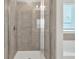 Modern glass-enclosed shower featuring tile and modern fixtures at 211 Aspen Valley Ln, Dallas, GA 30157