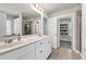 Bright, neutral bathroom with a double vanity and a glass-enclosed shower adjacent to walk-in closet at 211 Aspen Valley Ln, Dallas, GA 30157