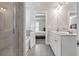 Bright bathroom featuring double sink vanity and a separate shower and tub, with views into the bedroom at 211 Aspen Valley Ln, Dallas, GA 30157