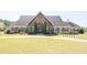 Charming clubhouse features a stone entrance, shuttered windows, and well-manicured landscaping at 211 Aspen Valley Ln, Dallas, GA 30157