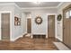 Entryway with hardwood floors, storage bench, neutral walls, and decorative mirror at 211 Aspen Valley Ln, Dallas, GA 30157