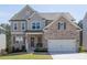 Charming two-story home with a brick facade, well-maintained lawn, and inviting front porch at 211 Aspen Valley Ln, Dallas, GA 30157