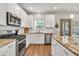 A kitchen with stainless steel appliances, granite countertops, and white cabinets at 211 Aspen Valley Ln, Dallas, GA 30157