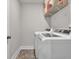 Laundry room with modern washer and dryer units at 211 Aspen Valley Ln, Dallas, GA 30157