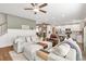 Spacious living area next to the open kitchen and stairs, with a ceiling fan at 211 Aspen Valley Ln, Dallas, GA 30157