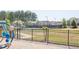 Oakleigh Pointe community tennis courts and playground with black fencing and professional lighting at 211 Aspen Valley Ln, Dallas, GA 30157