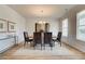 Formal dining room with wood floors, neutral walls, large windows, and modern chandelier at 376 Collier Mills Rd Dr, Lawrenceville, GA 30045