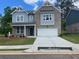 Charming two-story home with brick and siding, a two-car garage, and a well-manicured front yard at 376 Collier Mills Rd Dr, Lawrenceville, GA 30045
