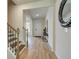Open hallway with wood floors, staircase, and modern decorative mirror at 376 Collier Mills Rd Dr, Lawrenceville, GA 30045