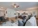 Open-concept living room features a ceiling fan, modern furniture, and seamless flow into the dining area and kitchen at 376 Collier Mills Rd Dr, Lawrenceville, GA 30045