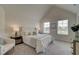 Bright main bedroom has vaulted ceiling, two windows, plush carpet, and neutral decor at 376 Collier Mills Rd Dr, Lawrenceville, GA 30045