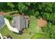 Aerial view of the backyard with a manicured lawn and surrounding mature trees at 4383 Capstone Ne Ct, Roswell, GA 30075
