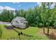 Expansive backyard with a black wooden fence and view of the back of the home, with a porch at 4383 Capstone Ne Ct, Roswell, GA 30075