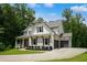 Beautiful two-story home with a well-manicured lawn, dark shutters and an attached two-car garage at 4383 Capstone Ne Ct, Roswell, GA 30075