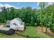 Exterior view of the home with a black wooden fence and view of the side entry two-car garage at 4383 Capstone Ne Ct, Roswell, GA 30075