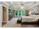 Spacious main bedroom with a tray ceiling, ceiling fan, picture windows, wood floors, and sitting area at 4383 Capstone Ne Ct, Roswell, GA 30075