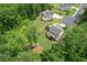 Aerial showcases the house nestled among the trees and green spaces, complemented by lush lawns at 4383 Capstone Ne Ct, Roswell, GA 30075