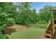 A backyard with large green lawn area and wooden deck at 4383 Capstone Ne Ct, Roswell, GA 30075