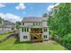 Exterior of home featuring backyard deck, manicured lawn, and lush greenery for privacy at 4383 Capstone Ne Ct, Roswell, GA 30075