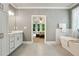 Bright bathroom with a soaking tub, walk-in shower, vanity, and tile floors at 4383 Capstone Ne Ct, Roswell, GA 30075
