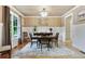 Elegant dining room with hardwood floors, wainscoting, modern light fixture and neutral color palette at 4383 Capstone Ne Ct, Roswell, GA 30075