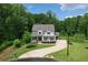 Beautiful home with a manicured lawn and a long driveway leads to a garage at 4383 Capstone Ne Ct, Roswell, GA 30075