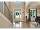 Inviting foyer with hardwood floors, staircase, elegant trim, and natural light pouring through the front door at 4383 Capstone Ne Ct, Roswell, GA 30075