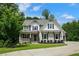 Charming two-story home with beautiful landscaping, symmetrical windows, and a welcoming front porch at 4383 Capstone Ne Ct, Roswell, GA 30075