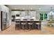 Bright kitchen features stainless steel appliances, white cabinets, an island with seating, and a breakfast area at 4383 Capstone Ne Ct, Roswell, GA 30075