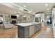 Open-concept kitchen with a large island, stainless steel appliances, and view to the living room at 4383 Capstone Ne Ct, Roswell, GA 30075
