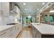 Stylish kitchen featuring white countertops and cabinets, stainless steel appliances, and eat-in dining area at 4383 Capstone Ne Ct, Roswell, GA 30075