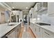 Modern kitchen featuring white cabinets, stainless appliances, a long island and hardwood flooring at 4383 Capstone Ne Ct, Roswell, GA 30075