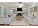 Bright living room features a brick fireplace, built-in shelving, and hardwood floors at 4383 Capstone Ne Ct, Roswell, GA 30075