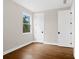 Bedroom featuring hardwood floors, natural light and white trim at 527 Pearl St, Cumming, GA 30040