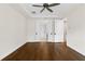 Bright bedroom featuring hardwood floors, a ceiling fan and white trim at 527 Pearl St, Cumming, GA 30040