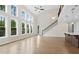 Bright living room boasting soaring ceilings, large windows, and hardwood flooring at 527 Pearl St, Cumming, GA 30040