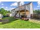 Spacious backyard offers a large lawn, patio seating area, and a wood deck perfect for entertaining at 995 Chimney Trace Way, Lawrenceville, GA 30045
