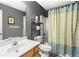 Bathroom features a vanity with a sink, toilet, and shower with a decorative curtain at 995 Chimney Trace Way, Lawrenceville, GA 30045