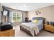 Comfortable bedroom with plush gray headboard, patterned bedding, and natural light at 995 Chimney Trace Way, Lawrenceville, GA 30045