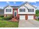 Charming two-story home featuring brick accents, black shutters and a well-manicured lawn at 995 Chimney Trace Way, Lawrenceville, GA 30045