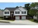 Charming two-story home with brick and white siding, two car garage, and well-maintained landscaping at 995 Chimney Trace Way, Lawrenceville, GA 30045