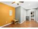 Neutral-toned hallway with laminate floors leads to an orange accent wall at 995 Chimney Trace Way, Lawrenceville, GA 30045