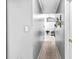 Clean hallway leads to a naturally lit living area, complemented by neutral color schemes at 995 Chimney Trace Way, Lawrenceville, GA 30045