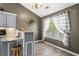 Bright eat-in kitchen area with a window, bar seating, and tile flooring at 995 Chimney Trace Way, Lawrenceville, GA 30045