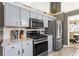 Modern kitchen with stainless steel appliances, granite countertops, and grey cabinetry at 995 Chimney Trace Way, Lawrenceville, GA 30045