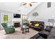 Cozy living room with fireplace, ceiling fan, comfortable seating, and plenty of natural light at 995 Chimney Trace Way, Lawrenceville, GA 30045